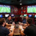 Tỷ lệ kèo trực tuyến displayed vividly at an active sports betting lounge filled with enthusiastic bettors.